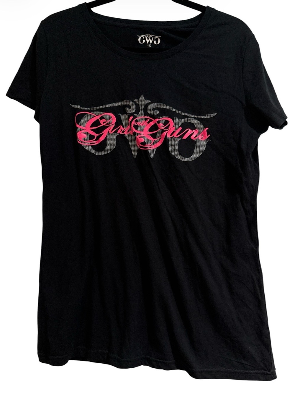 🆕  Girls with Guns black t-shirt features a prominent pink graphic logo